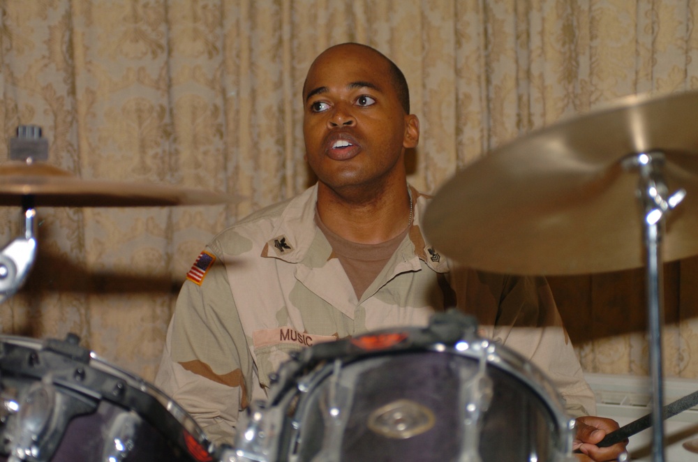 Petty Officer 1st Class Michael Music plays drums