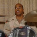 Petty Officer 1st Class Michael Music plays drums