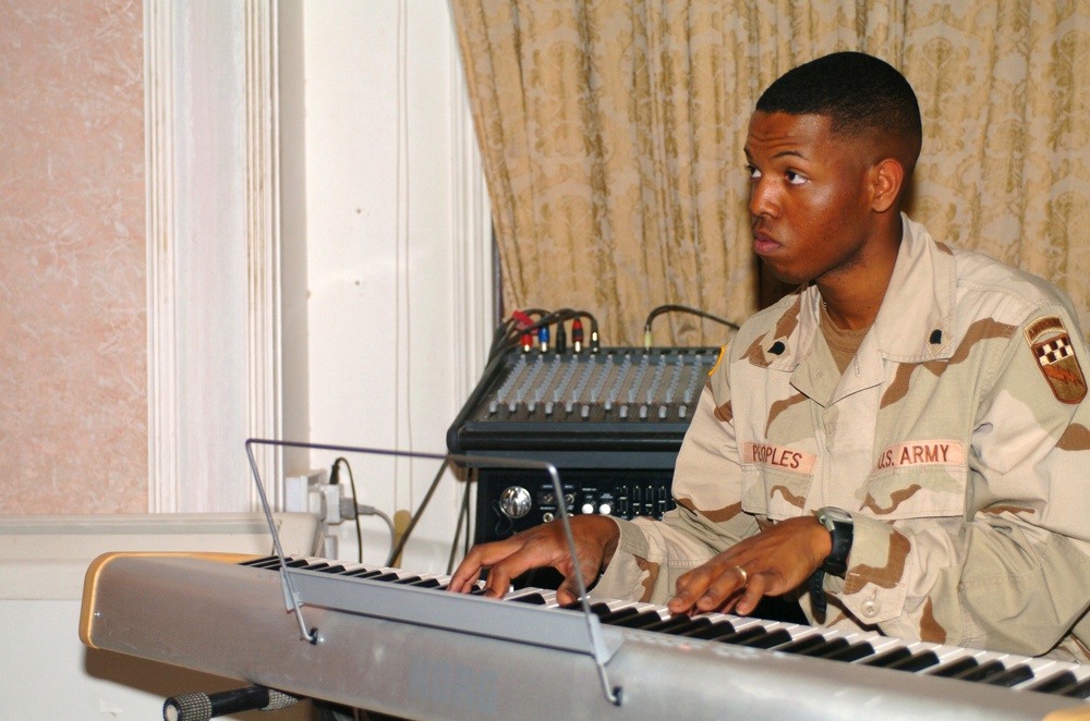 Spc. Jason Peoples accompanies the choir on piano