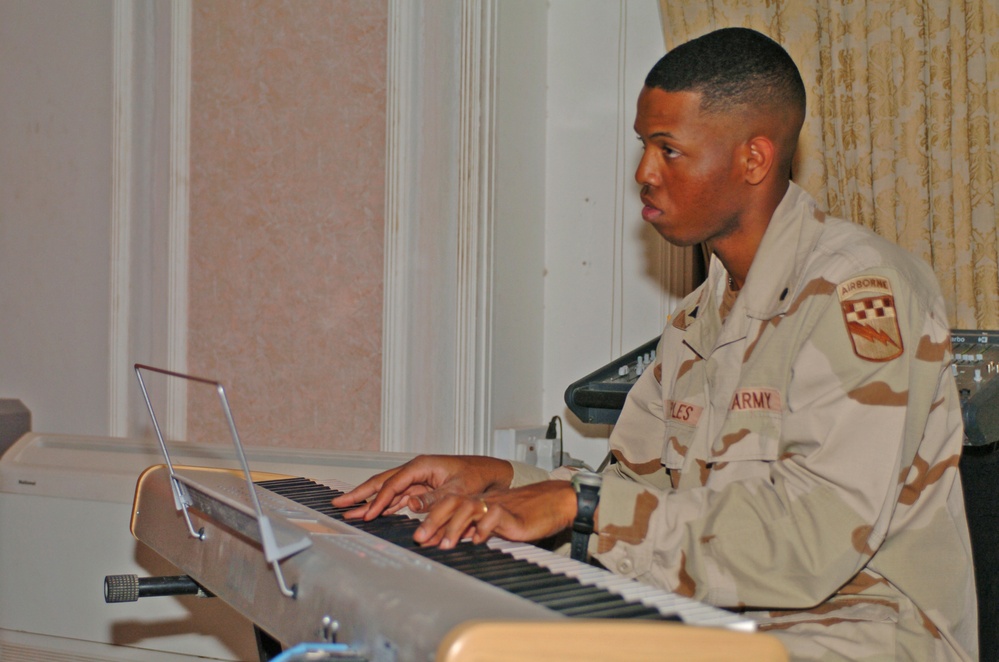 Spc. Jason Peoples accompanies the choir on piano