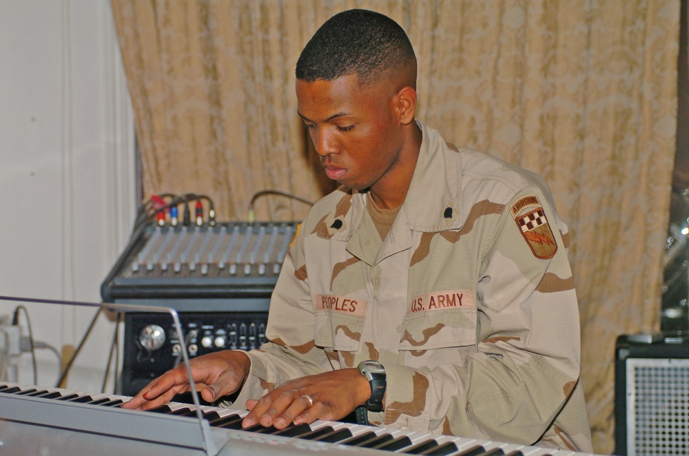 Spc. Jason Peoples accompanies the choir on piano