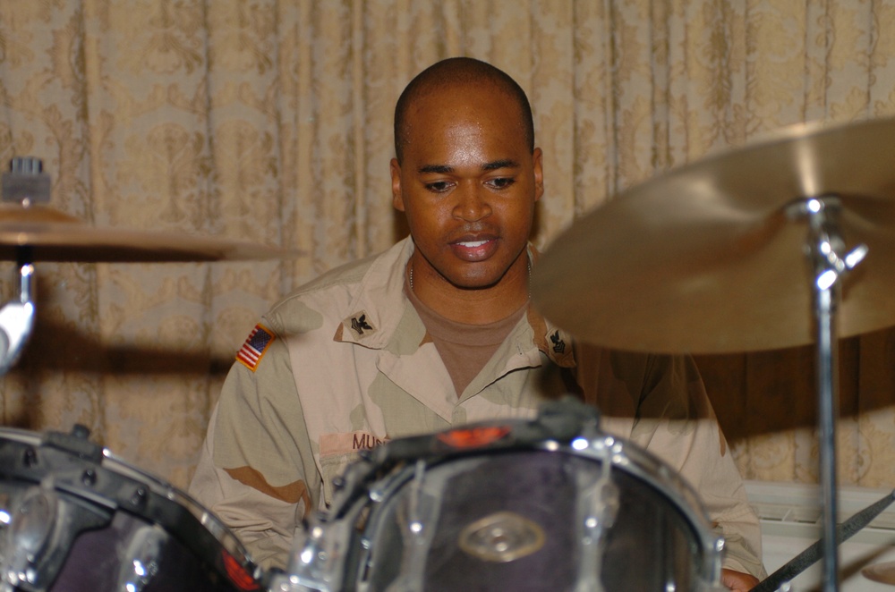 Petty Officer 1st Class Michael Music plays drums