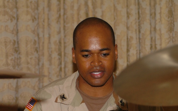 Petty Officer 1st Class Michael Music plays drums