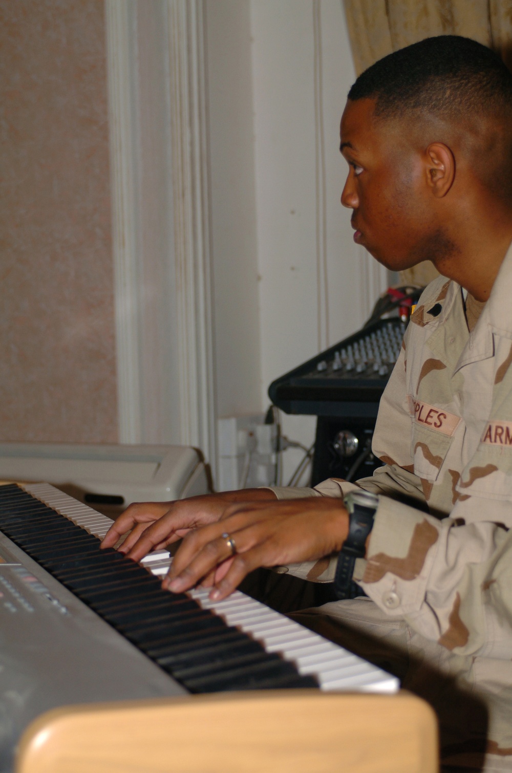 Spc. Jason Peoples accompanies the choir on piano