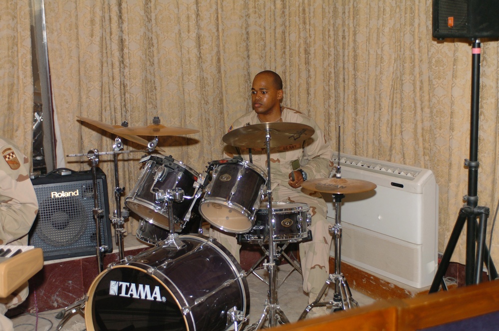 Petty Officer 1st Class Michael Music plays drums