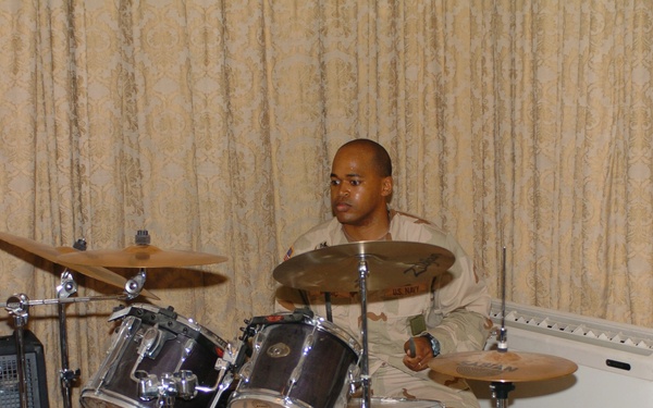 Petty Officer 1st Class Michael Music plays drums