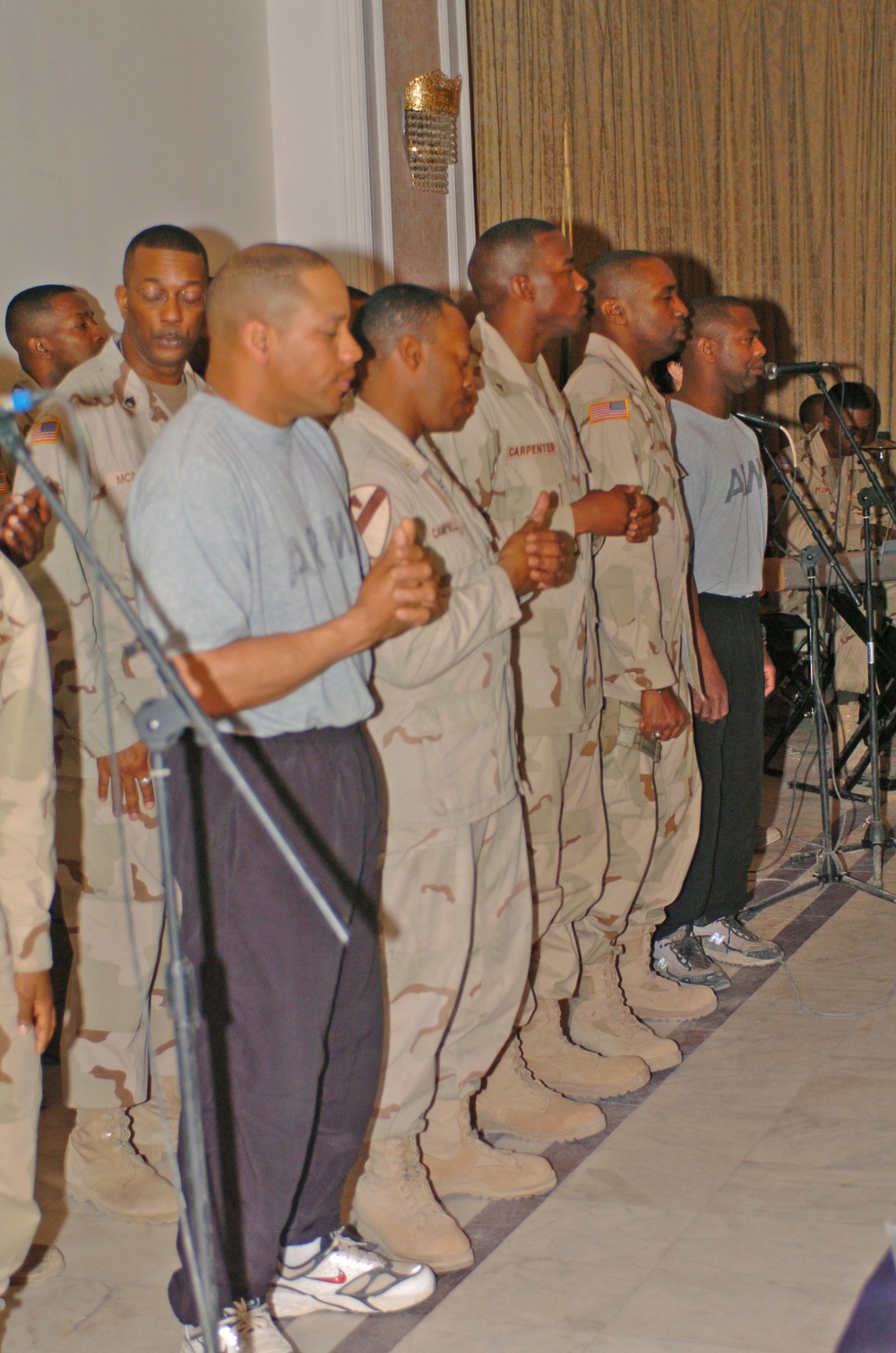 Members of the Camp Victory, Iraq, gospel choir pray