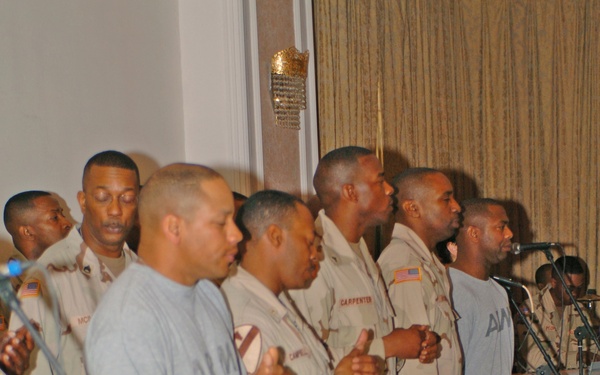 Members of the Camp Victory, Iraq, gospel choir pray