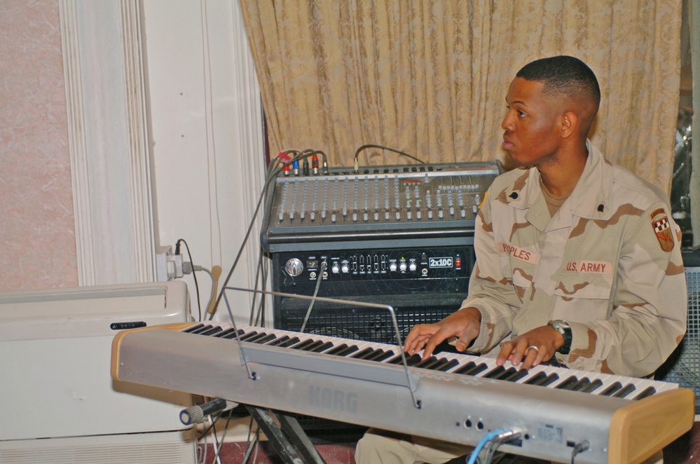 Spc. Jason Peoples accompanies the choir on the piano