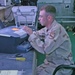 Pfc. Logan M. Radish works on a broken printer