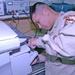 Staff Sgt. Roddy S. Nguyen repairs a copy machine