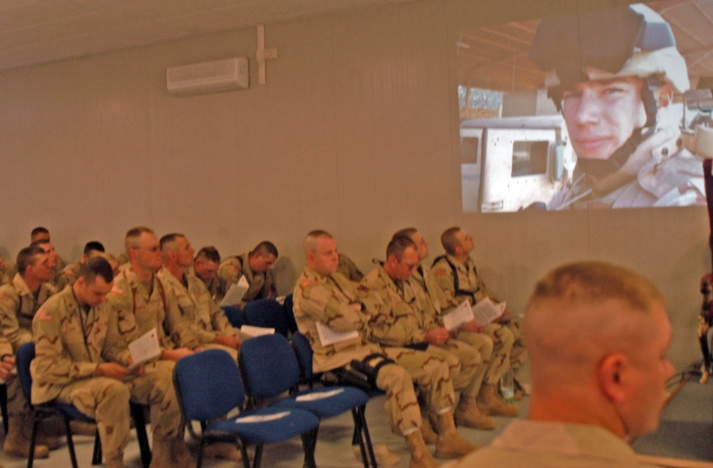 Soldiers reflect while watching a slideshow