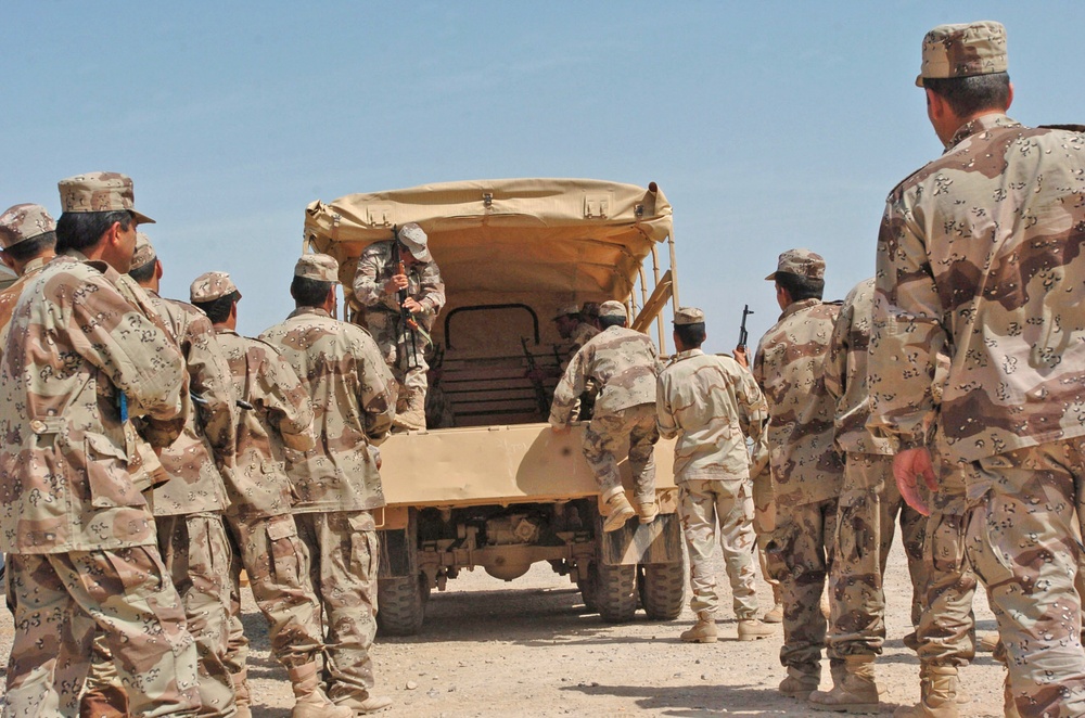 Iraqi National Guard soldiers load onto a truck