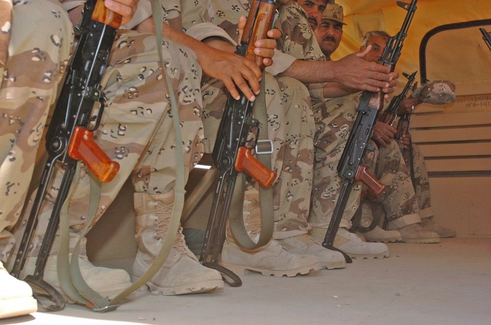 Iraqi National Guard soldiers load onto a truck