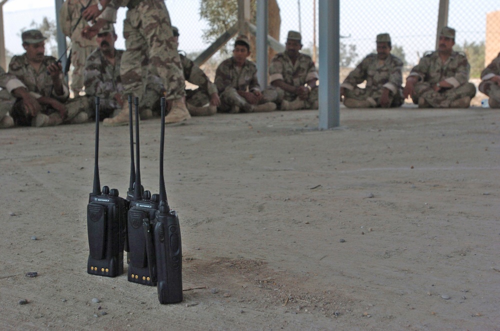 Iraqi National Guard soldiers sit in the shade