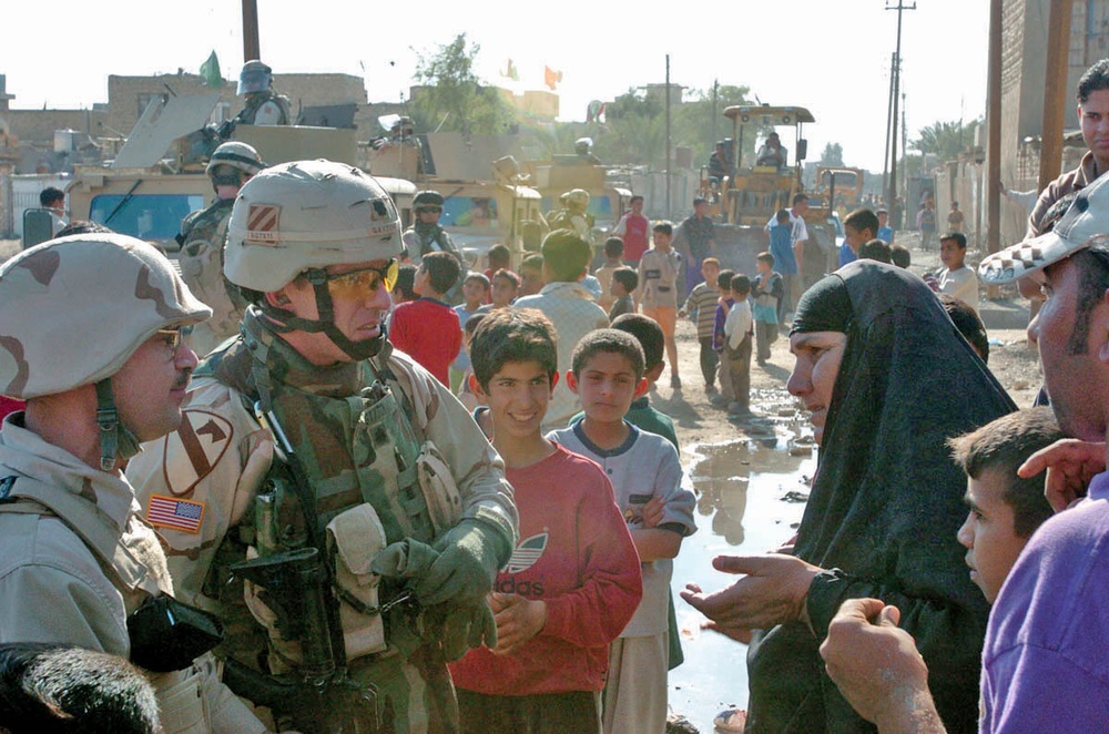 Lt. Col. Jamie Gayton speaks with a local woman
