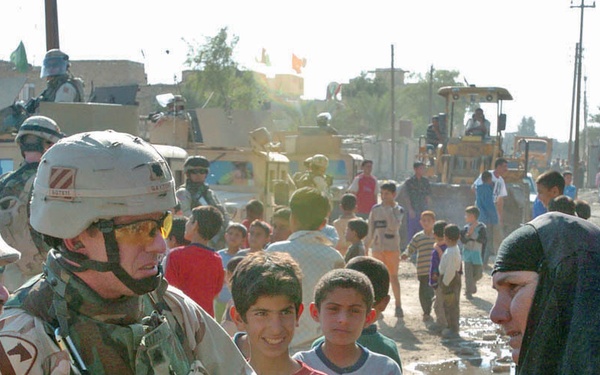 Lt. Col. Jamie Gayton speaks with a local woman
