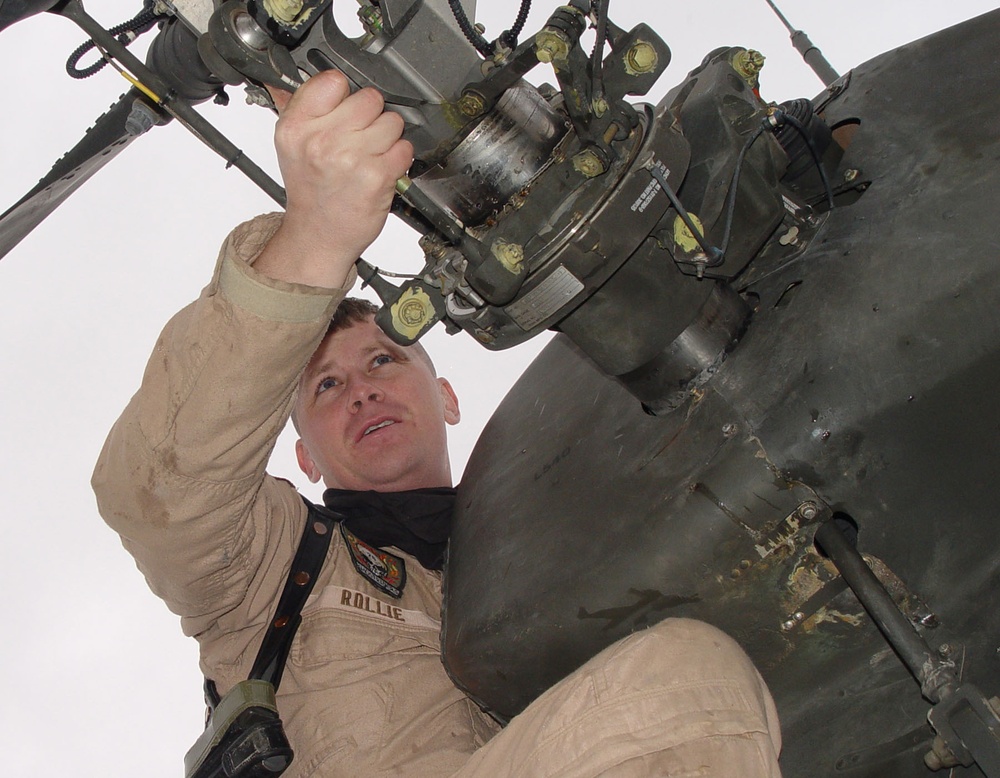 Capt. Beau Rollie inspects the tail rotor of his UH-64D