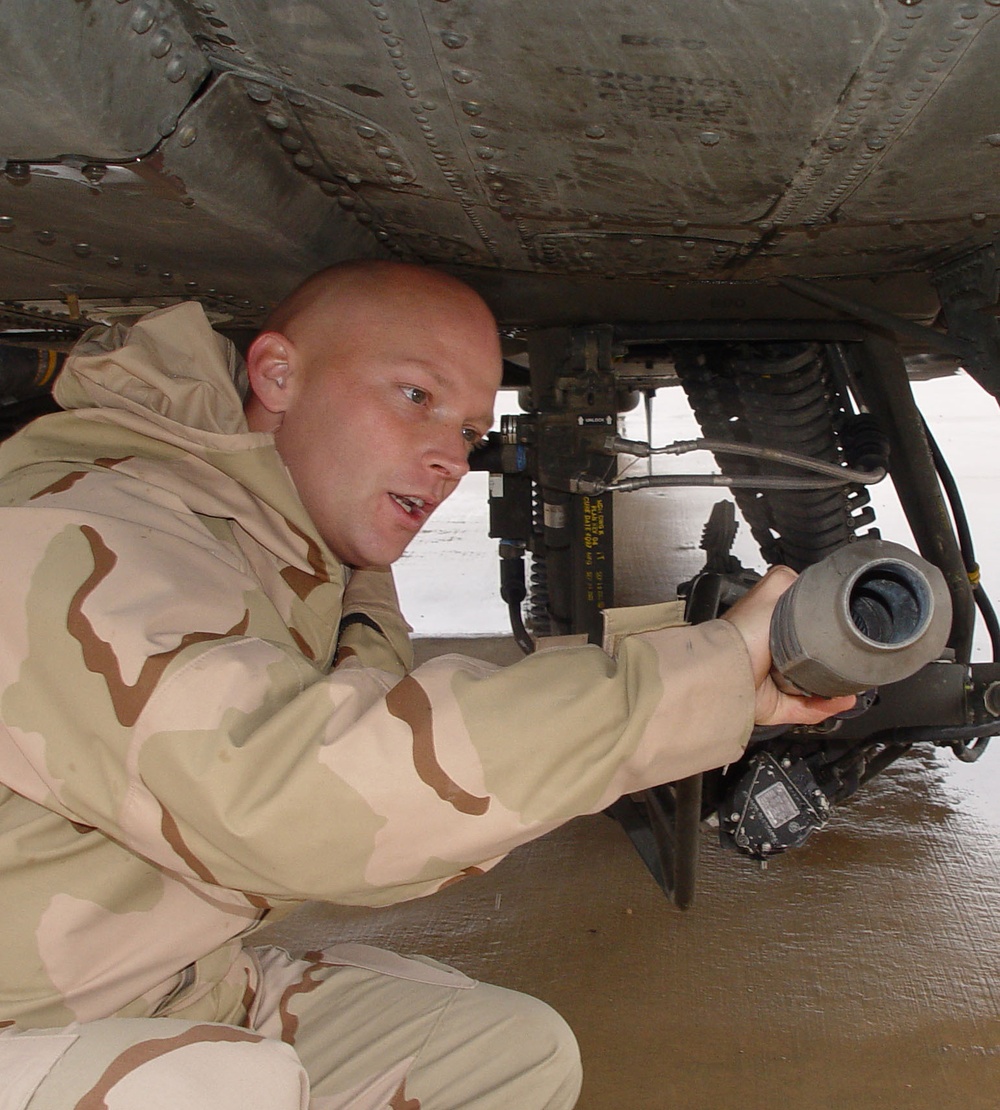 CWO Thad Menold inspects the machine gun