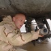 CWO Thad Menold inspects the machine gun