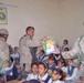 Sgt. Daniel Prime distributes school supplies to children