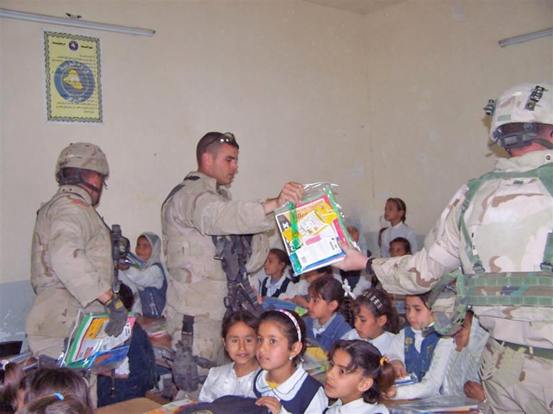Sgt. Daniel Prime distributes school supplies to children