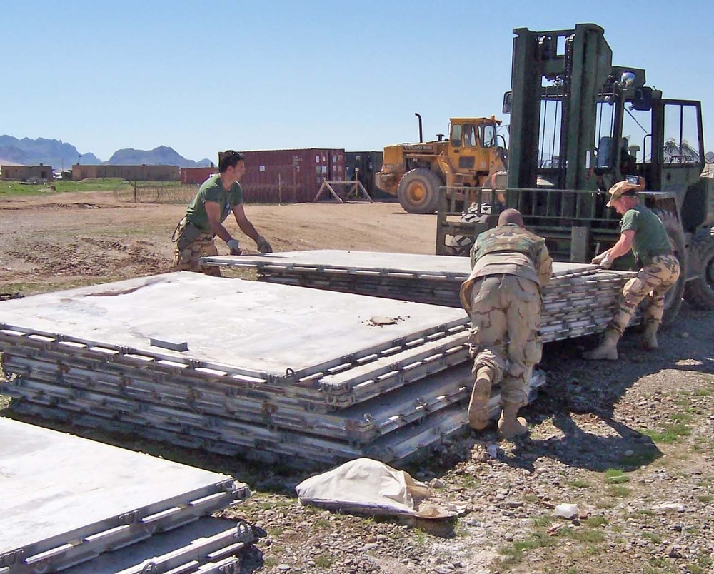 Soldiers work to consolidate about 120 pallets found