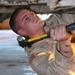 Spc. Tompkins hammers at a bolt on the gearbox