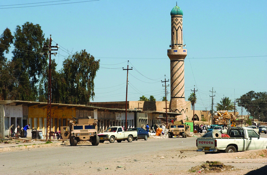 Soldiers stop traffic and search the town