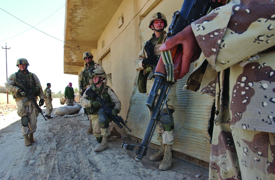 Soldiers search the streets and buildings of Al Huway Jah