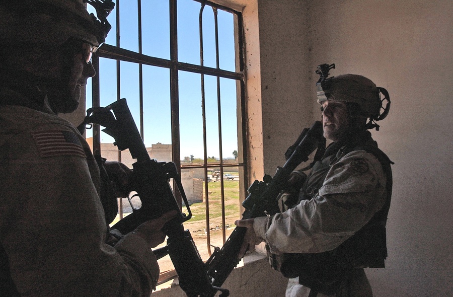 Two Soldiers discuss the sniper attack on their patrol