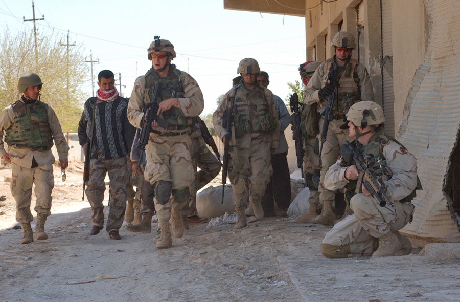 Soldiers search the streets and buildings of Al Huway Jah