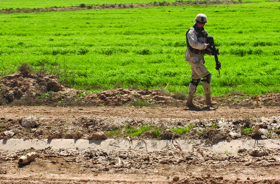 Staff Sgt. Rick Haerter examines an artillery round found