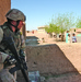 Spc. Jeremy Bosch exits a storage room after a (soft-search).