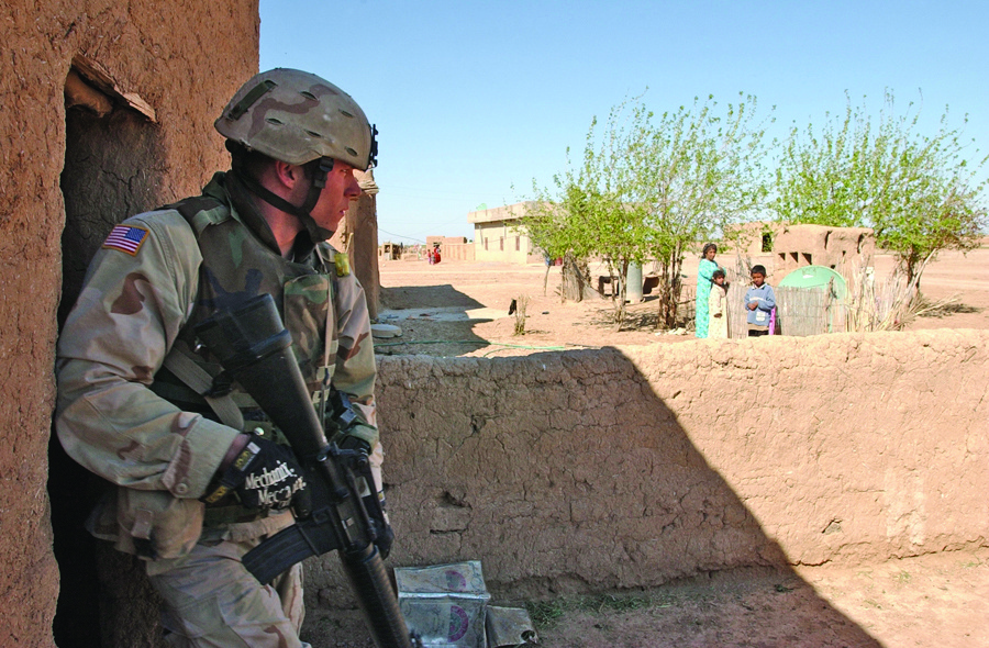 Spc. Jeremy Bosch exits a storage room after a (soft-search).