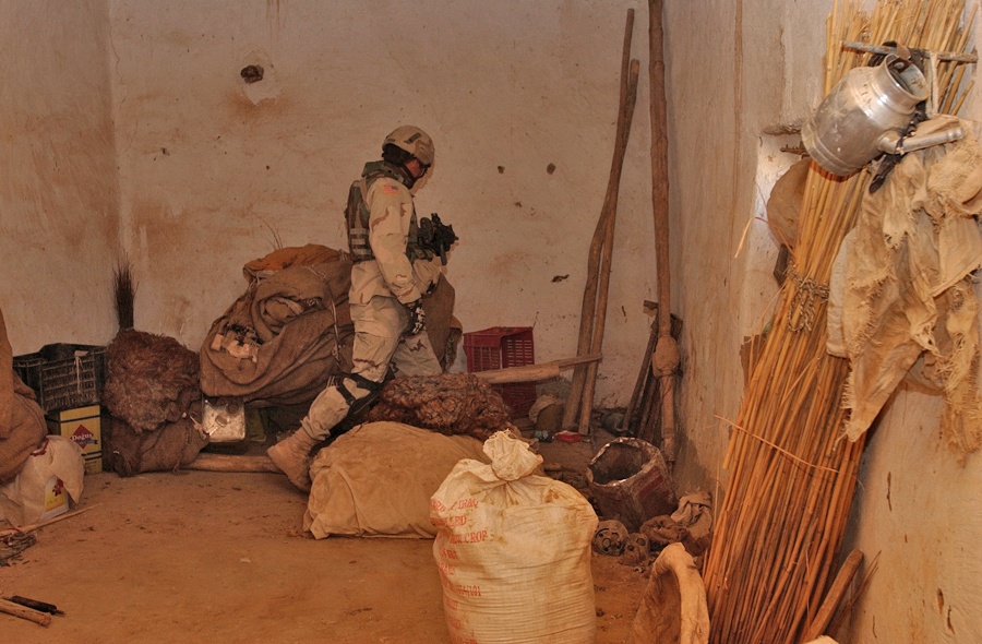 Spc. Jeremy Bosch searches a storage room