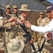 Larry Izzo hands an autographed disc to a soldier