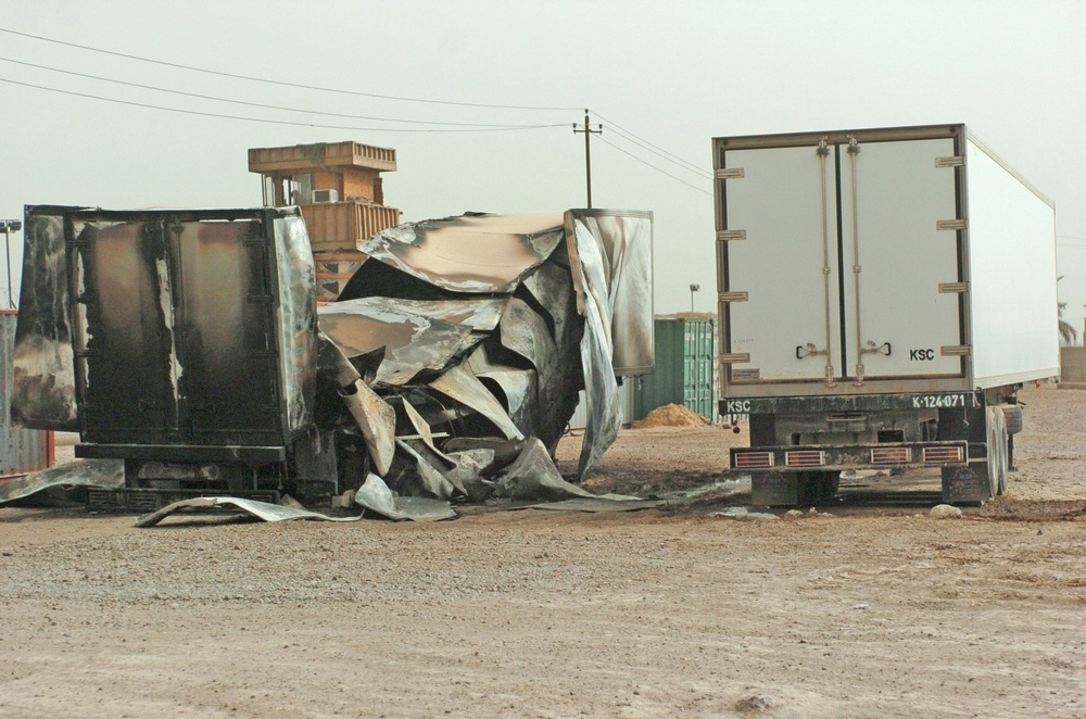 The cargo trailer on the left was destroyed by a mortar round