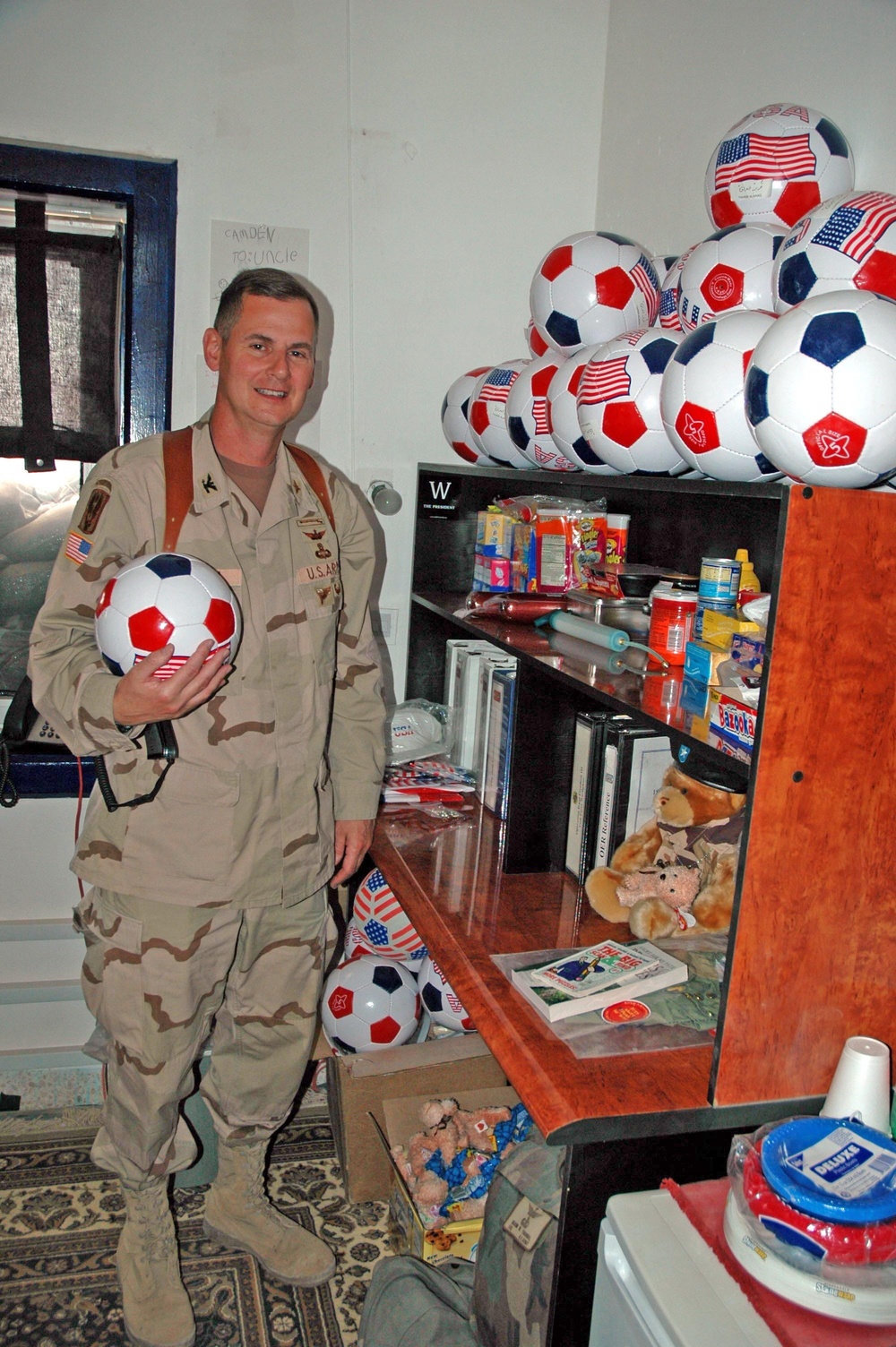 Col. Mason Thorna with the soccer balls his family sent