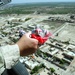 A Soldier prepare to drop a (candy bomb) from UH-60 BlackHawk