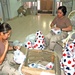 Two soldiers prep boxes full of soccer balls