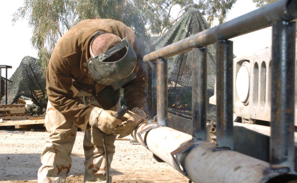 Sgt. Morris Steiner welds a bumper on a humvee