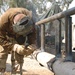 Sgt. Morris Steiner welds a bumper on a humvee