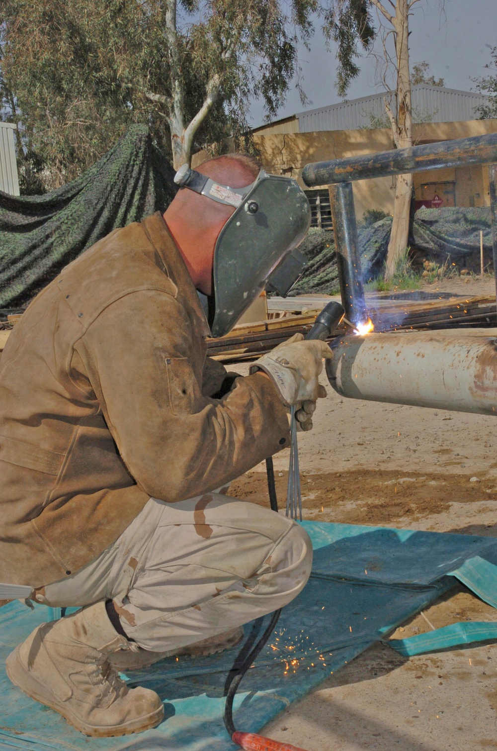 Sgt. Morris Steiner welds a bumper on a humvee