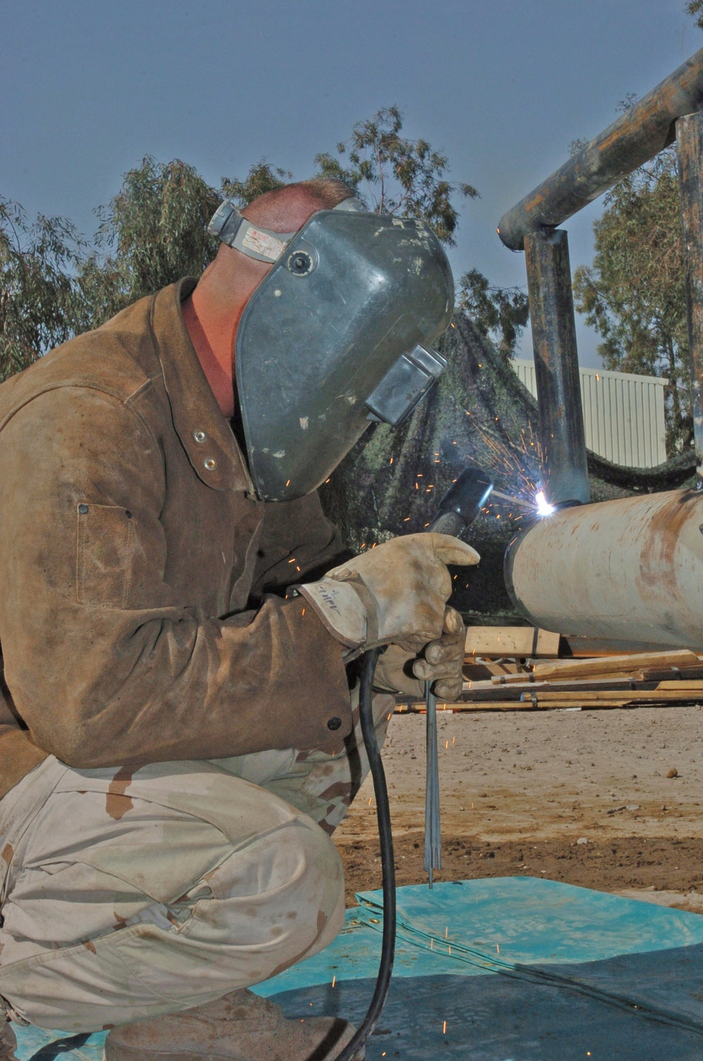 Sgt. Morris Steiner welds a bumper on a humvee