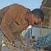 Spc. Michael D. Ross cuts out a piece of metal