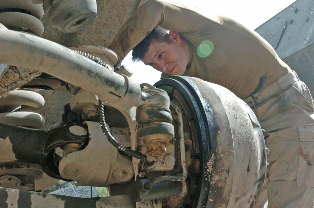 Sgt. Mark J. Meunier bleeds the brake line on his M1117