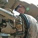 Sgt. Mark J. Meunier bleeds the brake line on his M1117