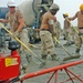 Soldiers lay concrete as part of the expansion of Camp Taji airf