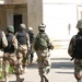 Soldiers head toward an old theater inhabited by squatters